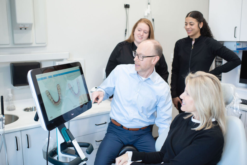 Dr Tim Hoftiezer showing patient her dental photos