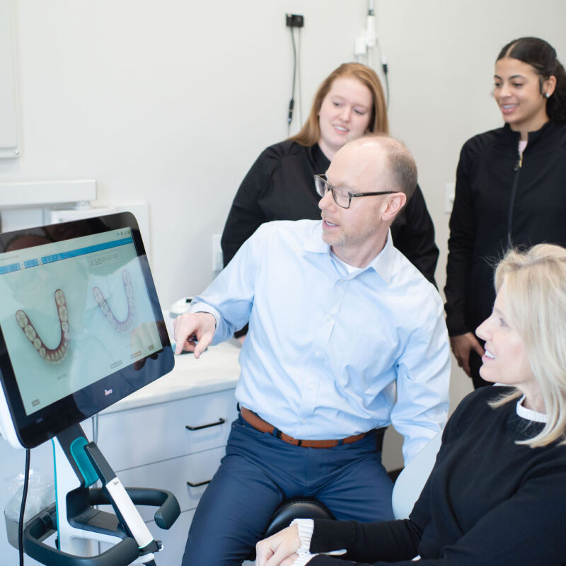 Dr Tim Hoftiezer showing patient her dental photos