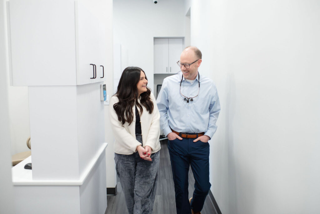 Patient walking with Dr Tim Hoftiezer in dental hallway